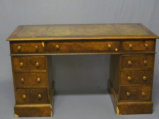 A Victorian walnut kneehole pedestal desk with green inset  tooled writing surface above 1 long and 8 short drawers 50"