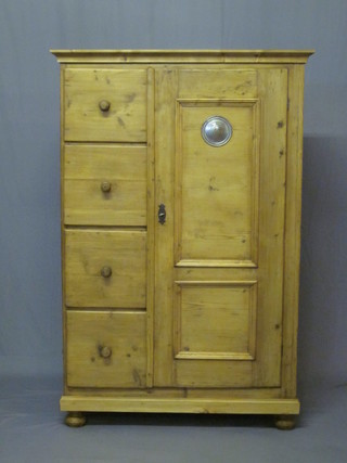 A Continental stripped and polished pine combination wardrobe fitted 4 short drawers, flanked by a cupboard 39"