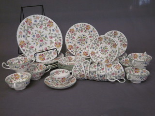 A 42 piece Minton Haddon Hall pattern dinner service  comprising 6 8" side plates, 6 10 1/2" dinner plates, 2 7" tea plates, 4 6 1/2" tea plates, 6 saucers, 7 tea cups - 1 cracked, 6  twin handled soup bowls and saucers