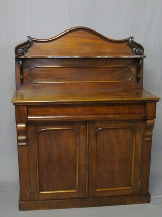 A Victorian mahogany chiffonier with raised shaped back, the  base fitted 1 long drawer above a double cupboard enclosed by  arched panelled doors, raised on a platform base 42"