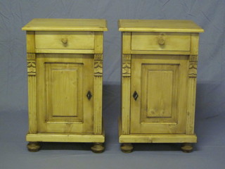 A pair of Continental stripped and polished pine bedside cabinets fitted a drawer above a cupboard, raised on bun feet 17"