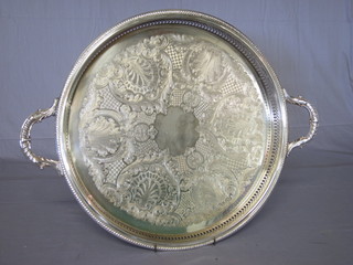 A circular pierced and engraved silver plated twin handled tea  tray with galleried decoration