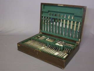 A canteen of silver plated Kings Pattern flatware contained in an oak canteen box
