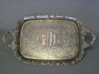 A silver plated twin handled tea tray with engraved decoration  and cast grape and ivy border 18"