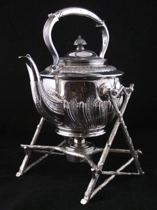 A Britannia metal tea kettle and stand raised on crabstock  supports, complete with burner, by Walker & Hall