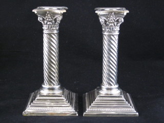 A pair of Victorian silver candlesticks with Corinthian capitals raised on square bases, London 1893 and 1894, 7"  ILLUSTRATED