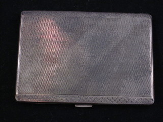 A silver cigarette case with engine turned decoration 4 ozs