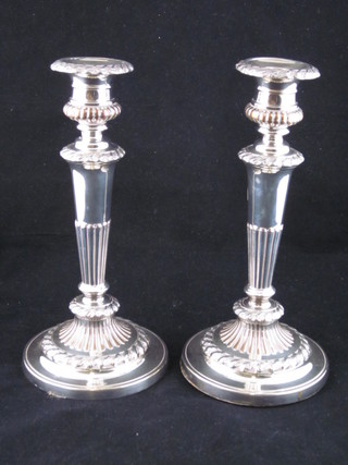 A pair of silver plated candlesticks with reeded decoration 9 1/2"
