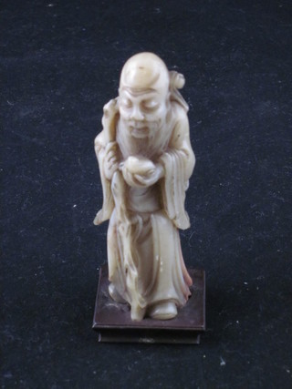 An Eastern carved white hardstone figure of a Deity 3"