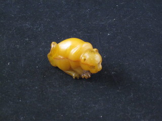 A carved amber coloured hardstone Netsuke in the form of a  monkey 1"
