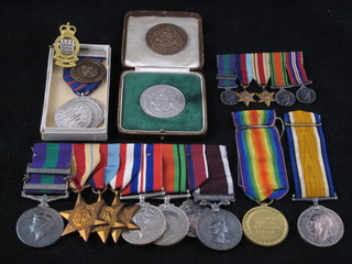 A family group, father and son, comprising a pair - British War medal and Victory medal to 319841 Saffa G E McGee Royal  Engineers together with a group of 8 medals comprising George  VI Issue Army RAF General Service medal 1918-62 2 bars  Palestine and Malaya, 39-45 Star, African Star, France &  German Star, British War medal and Victory medal, Queen  Elizabeth II Coronation medal and Queen Elizabeth Issue Army  Service Long Good Conduct medal, to 7587545 Pte. J E McGee  later Captain Royal Army Ordnance Corps, some privately  engraved together with a group of miniature medals, together  with a "silver" Wakefield medal, a bronze Wakefield medal, 3  Army Ordnance Corps Shooting medals and an Army Ordnance  Corps cap badge ILLUSTRATED