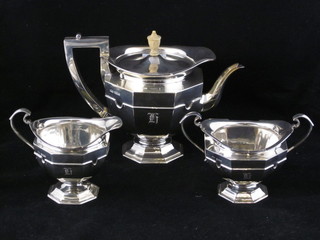 An Art Nouveau silver 3 piece tea service of octagonal form comprising teapot, twin handled sugar bowl and cream jug,  raised on octagonal spreading feet, Sheffield 1912, 31 ozs