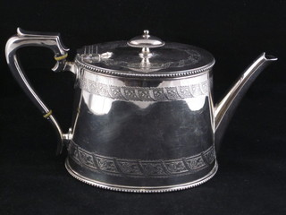 An oval silver plated teapot with engraved decoration