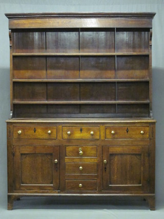 An 18th Century honey oak dresser, the raised back with  moulded cornice and fitted 3 shelves, the base fitted 3 long   drawers above 4 long drawers, flanked by a pair of cupboards  enclosed by panelled doors 59" ILLUSTRATED