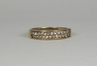 A gold half eternity ring set diamonds