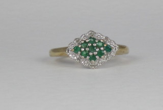 A 9ct yellow gold cluster ring set emeralds and diamonds