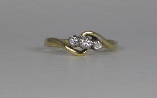An 18ct gold cross-over dress ring set 3 diamonds