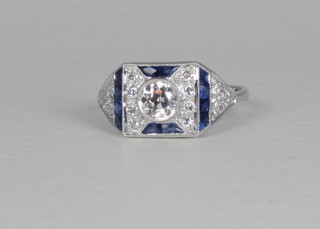 An 18ct white gold dress ring set a circular diamond surrounded  by diamonds and sapphires, approx 0.80ct