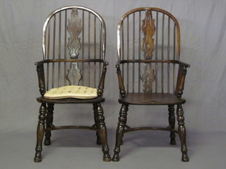 A pair of 17th Century style elm wheel back Windsor armchairs  with solid elm seats and cow horn stretchers, the base marked  1989 and with brass plaque marked Lefevre & Sons Chairmakers  Oxford