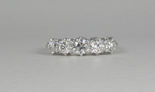 An 18ct white gold engagement/dress ring set 5 diamonds and  with 6 diamonds to the shoulders, approx 1.40ct
