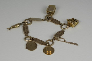 A 9ct gold charm bracelet hung 5 charms