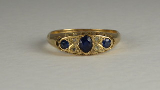An 18ct gold dress ring set blue stones
