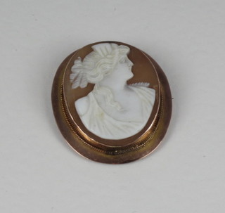 A shell carved cameo brooch contained in a gold mount