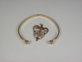 A gold pendant set blue stones together with a gilt metal bangle