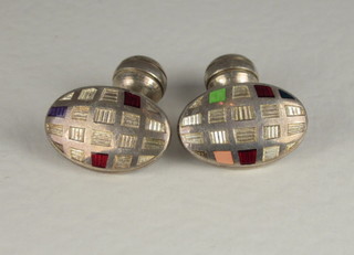 A pair of oval silver and enamelled cufflinks
