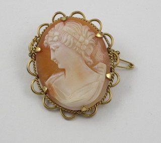 A gold brooch set a shell carved cameo portrait of a lady