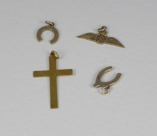 A gold cross, a gold RAF pendant and 2 horse shoe charms  