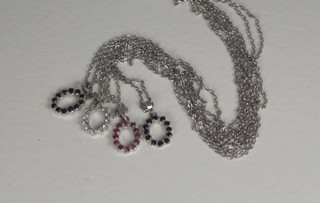 A fine silver chain hung a pendant set white stones, ditto set red stones and 2 others set blue stones