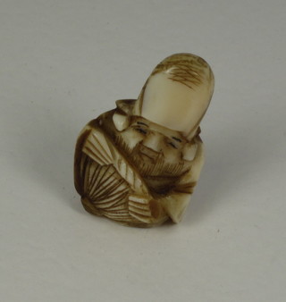 A miniature carved ivory Netsuke in the form of a man 1",