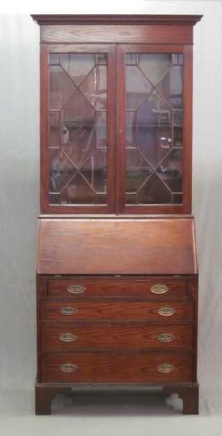An oak bureau bookcase, the upper section with moulded and  dentil cornice, the interior fitted shelves enclosed by astragal  glazed panelled doors, the fall front revealing a well fitted  interior above 4 long graduated drawers, raised on bracket feet  33"