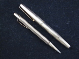 A Parker pen contained in a gilt metal case together with a gilt metal propelling pencil