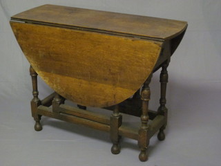 An 18th Century oak drop flap gateleg dining table, raised on  turned and block supports 37"