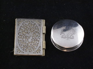 A cylindrical silver rouge pot London 1905 and a pierced silver miniature book cover