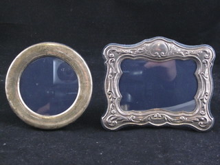 A circular silver easel photograph frame 3 1/2" and a rectangular silver photograph frame 4"