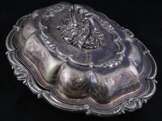 A shaped silver plated entree dish and cover