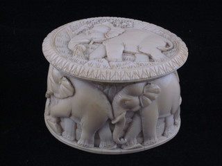 An oval carved ivory trinket box decorated elephants 3"