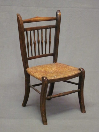 A Victorian beech stick and rail back child's chair with woven  rush seat