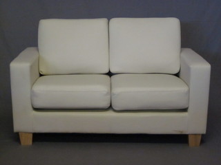 A 3 piece suite upholstered in white material comprising 2 seat  settee 63" and 2 matching armchairs