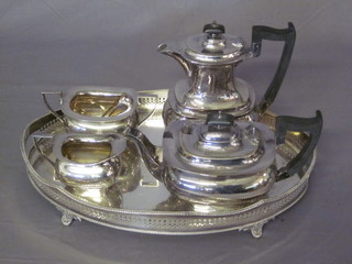 An oval silver plated tea tray and a 4 piece silver plated tea service by Walker & Hall comprising teapot, hotwater jug, twin  handled sugar bowl and cream jug
