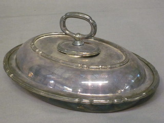 An oval silver plated entree dish and cover