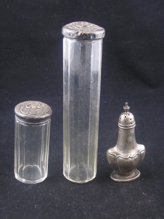 A silver pepperette and 2 cut glass pin jars with embossed silver lids