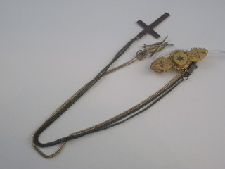 A gold brooch and 2 gilt metal chains hung a cross and Zulu  shield