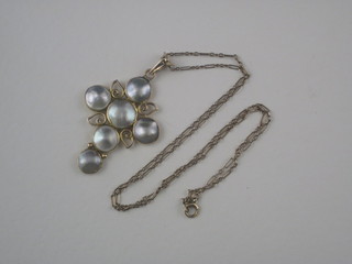An Arts and Crafts 15ct gold cross set pearls, hung on a 9ct gold chain