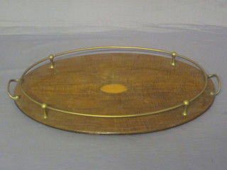 An oval inlaid mahogany tray with silver plated gallery 21"