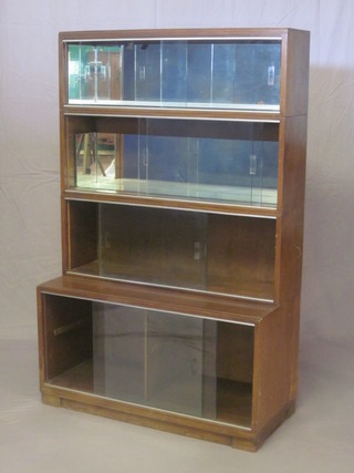 A walnut 4 tier Minty style bookcase with mirrored panels to the back enclosed by glazed sliding doors 35"