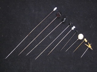 A collection of various hat pins